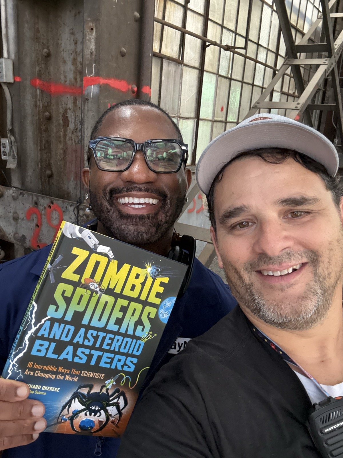 Mario Cruz with Maynard Okereke holding his book