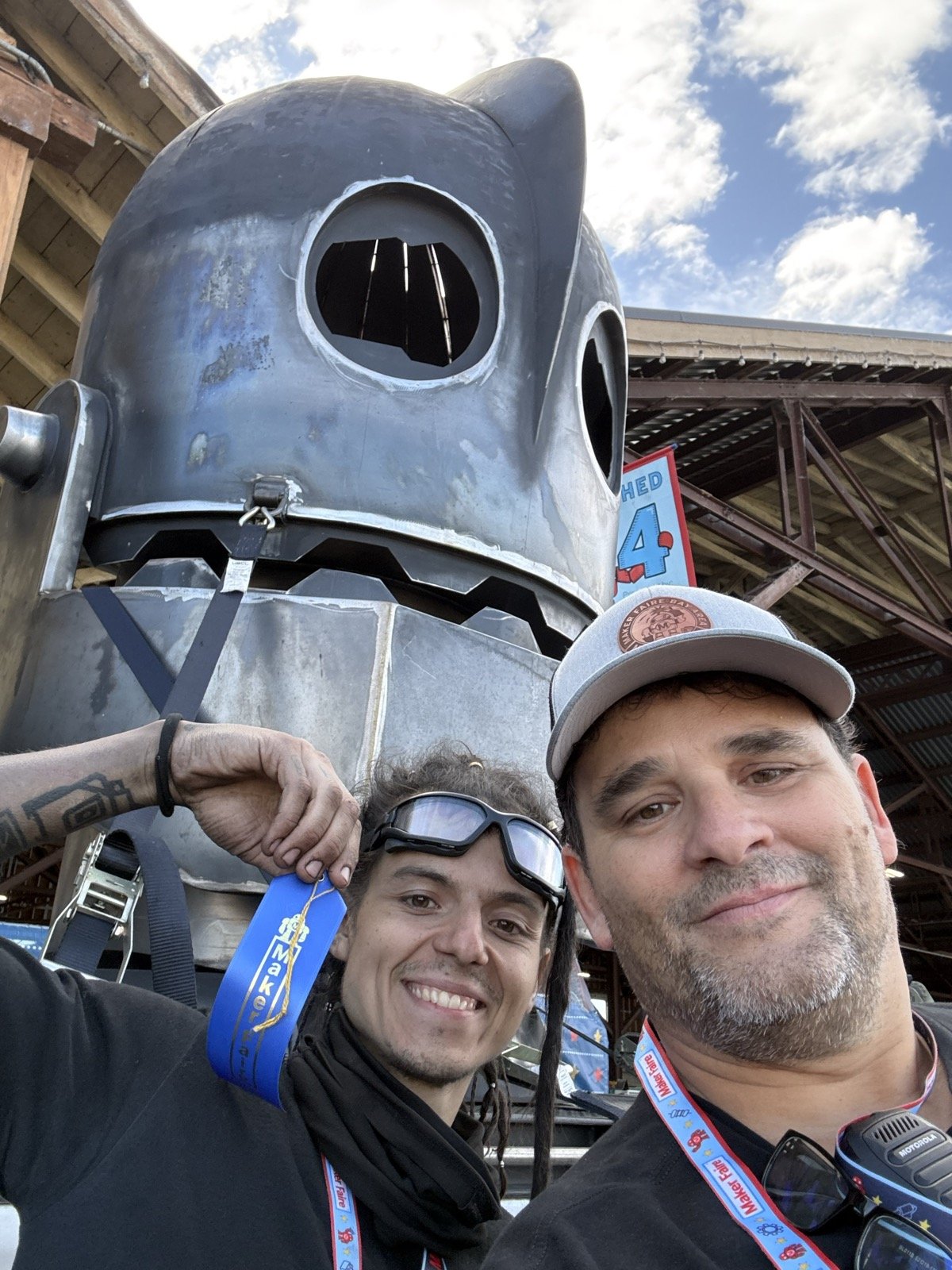 Mario Cruz and Chris Mora with his blue ribbon in front of the Iron Giant head