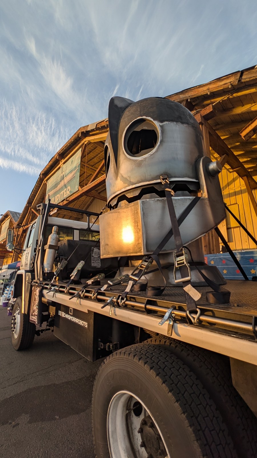 Giant steel Iron Giant head on a flatbed trailer at golden hour