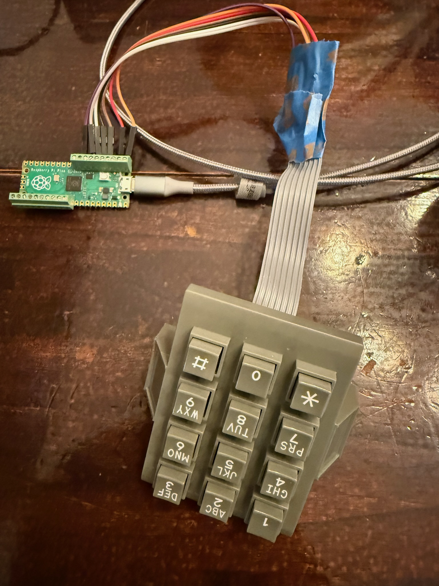 Raspberry Pi Pico wired to the phone keypad via ribbon cable